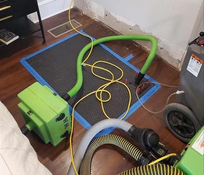 Special drying mat equipment on a wet hardwood floor